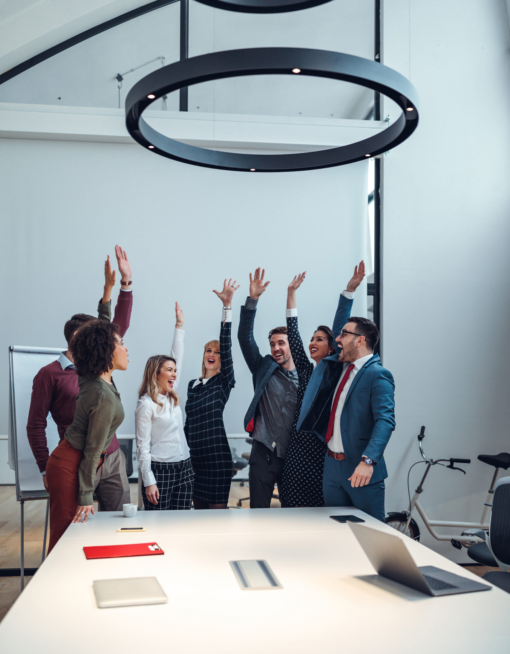 Group of coworkers cheering in an office